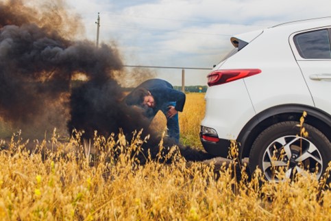 A frustrated motorist tries to find the problem with their non-running car