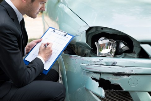 A man assessing a accident damage car for sale in Gauteng.